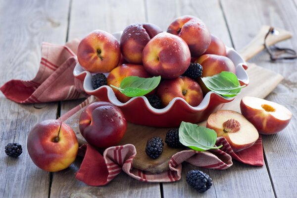 Still life of fresh nectarines and berries