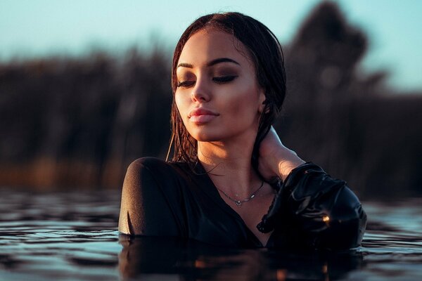 A nymph emerging from the depths of a dark lake