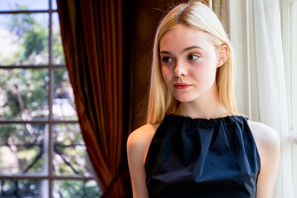 Young beautiful blonde girl at a press conference