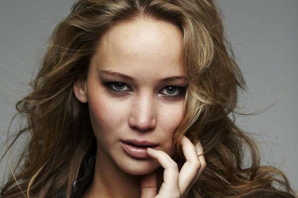 Portret Jennifer Lawrence z ręką przy ustach