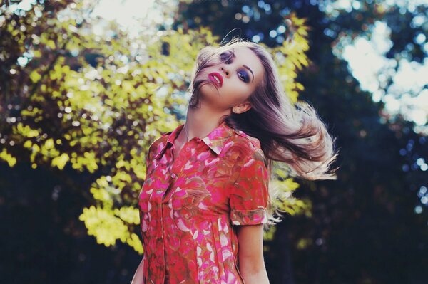 A girl in a dress against the background of nature