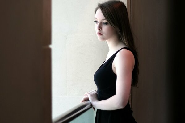 Portrait of a girl looking out the window