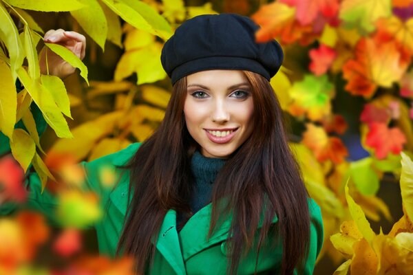 A girl in a beret and a green coat