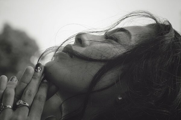 The profile of the girl and the hands as in prayer