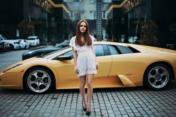 Girl Lera on the background of a yellow car