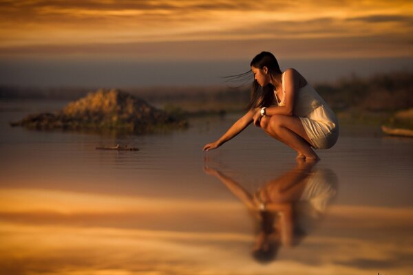 A girl in a white dress on the sea