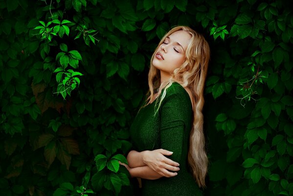 Portrait of a girl in green leaves