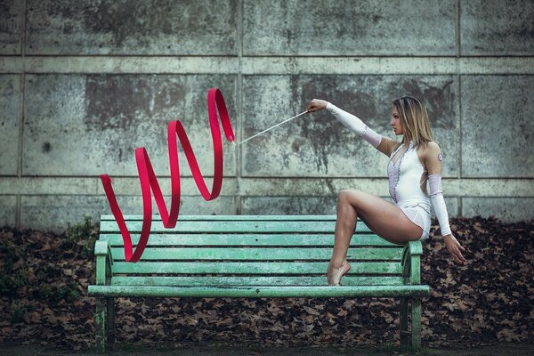 The girl is engaged in rhythmic gymnastics