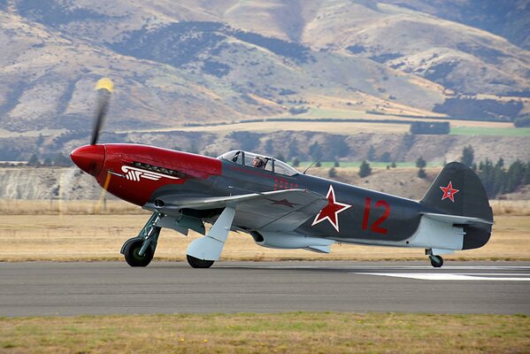 Single-engine Yak-3 aircraft with a red star