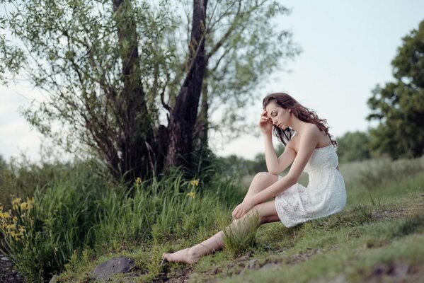 Photo of a girl in a white dress in nature