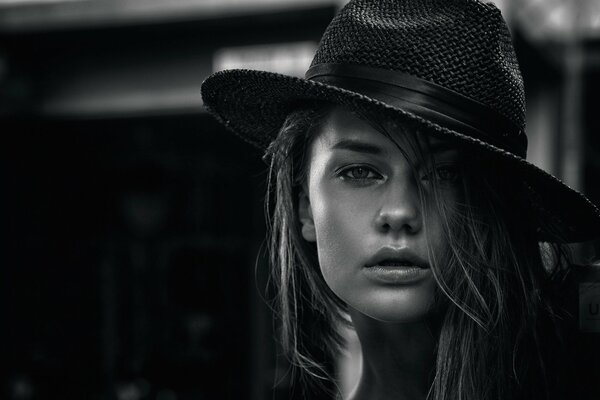 Beautiful girl in a hat black and white portrait