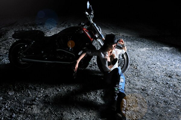 A girl with a motorcycle in the silence of the night