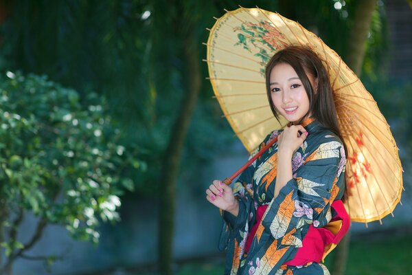 Bright Asian girl with an umbrella