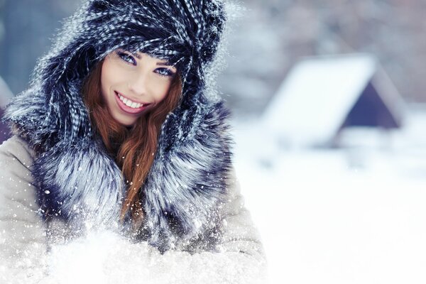 A girl with a beautiful smile in the snow