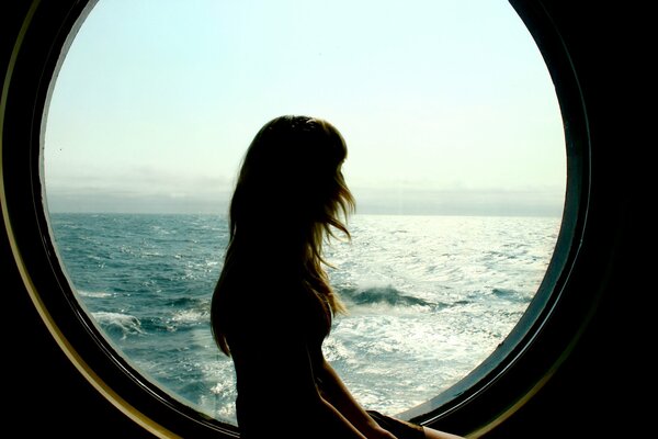 The girl looks at the sea