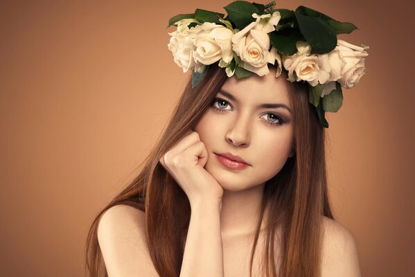 A wreath of roses on a young girl