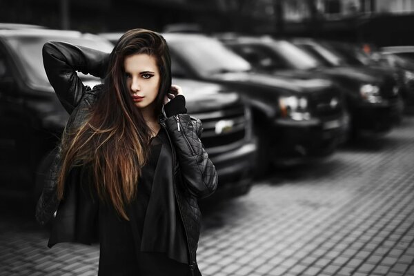 Beautiful girl on the background of cars