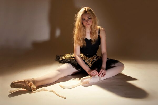 Ballerina in pointe shoes on the floor