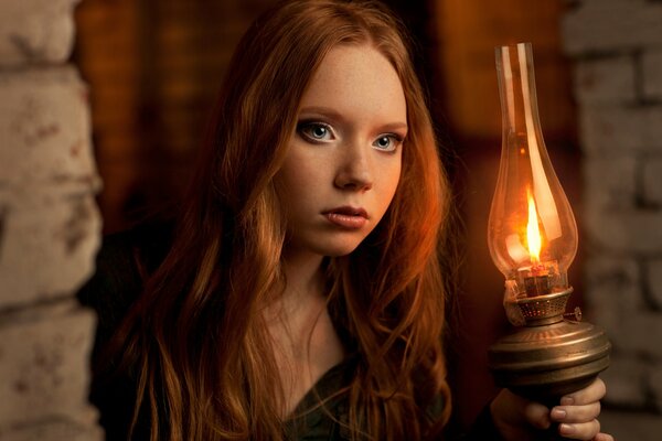 Mysterious red-haired girl with a lamp