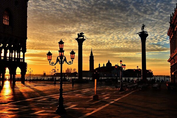 Italian embankment with lanterns on the background of the sunset sky