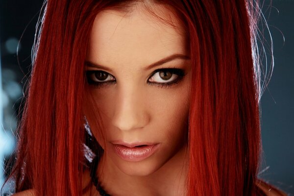 A girl with red hair and piercing eyes