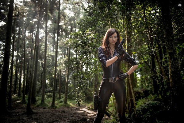 A girl with a gun alone in the middle of the forest