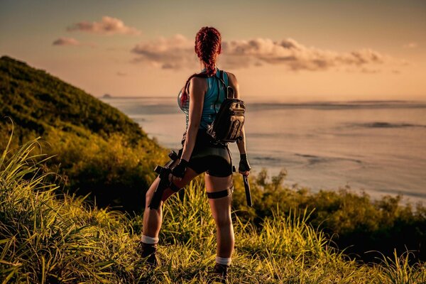 Lara Croft cosplay with weapons in nature