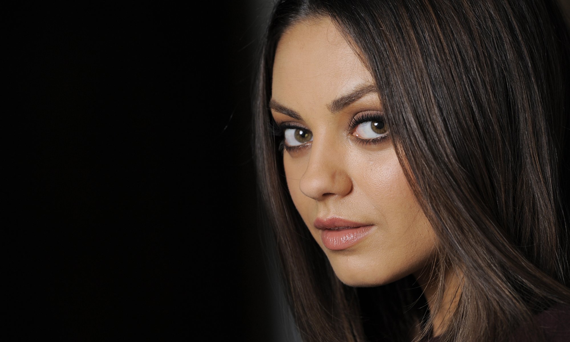 mila kunis actress face portrait black background