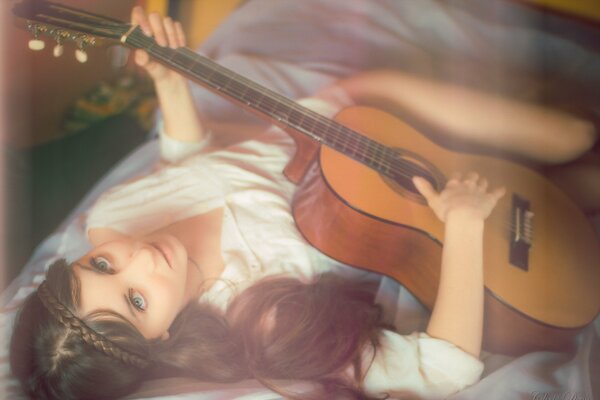 A girl with a guitar in her hands