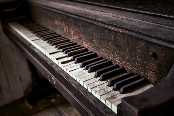 A shabby old piano with an old background