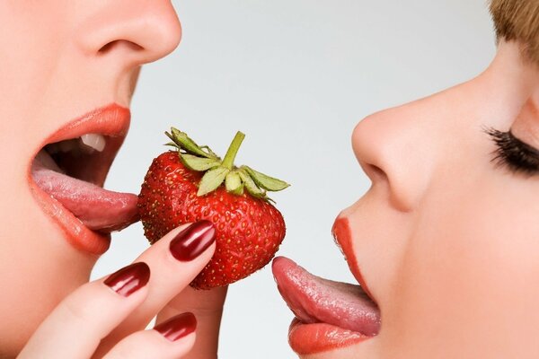 Two girls and a sweet strawberry