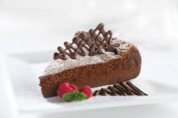 A piece of chocolate cake with raspberries