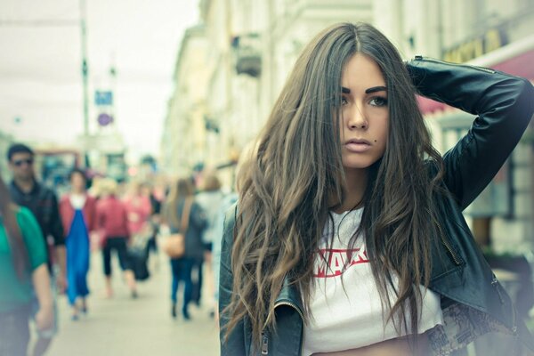 A girl with loose hair on a city street