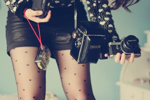 Different cameras in the hands of the girl