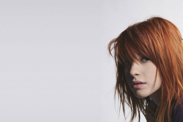 A girl with red hair on a white background