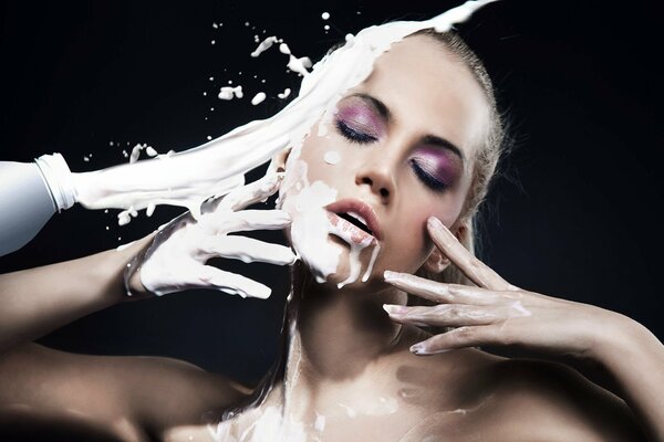 Milk splashes in the girl s face