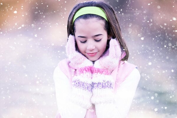 Cute girl with snowflakes of snow