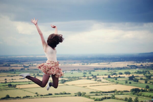 A girl against the sky in a jump