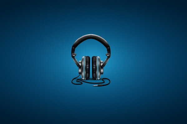 Black wired headphones on a dark blue background