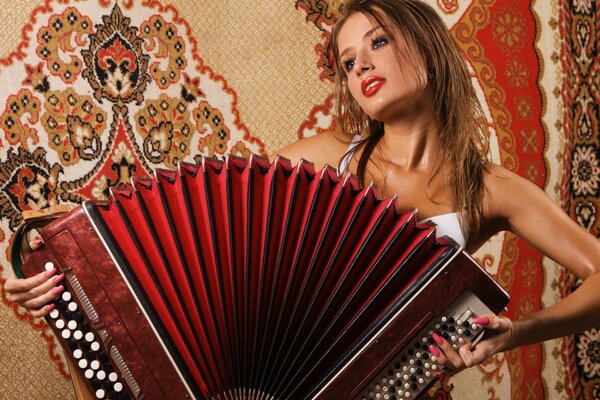 A girl with a bayan on a carpet background