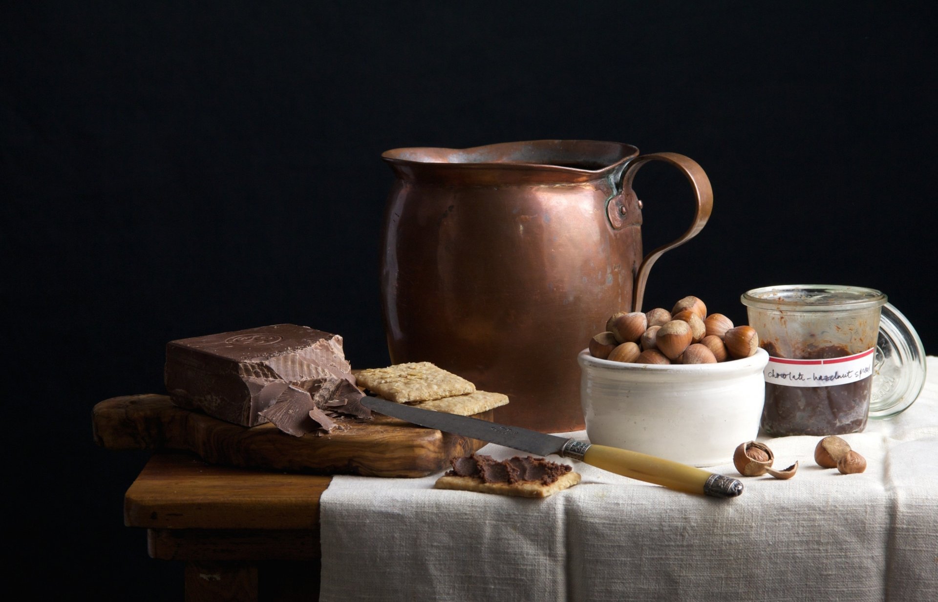 chocolate nuts cookies pitcher knife board table still life