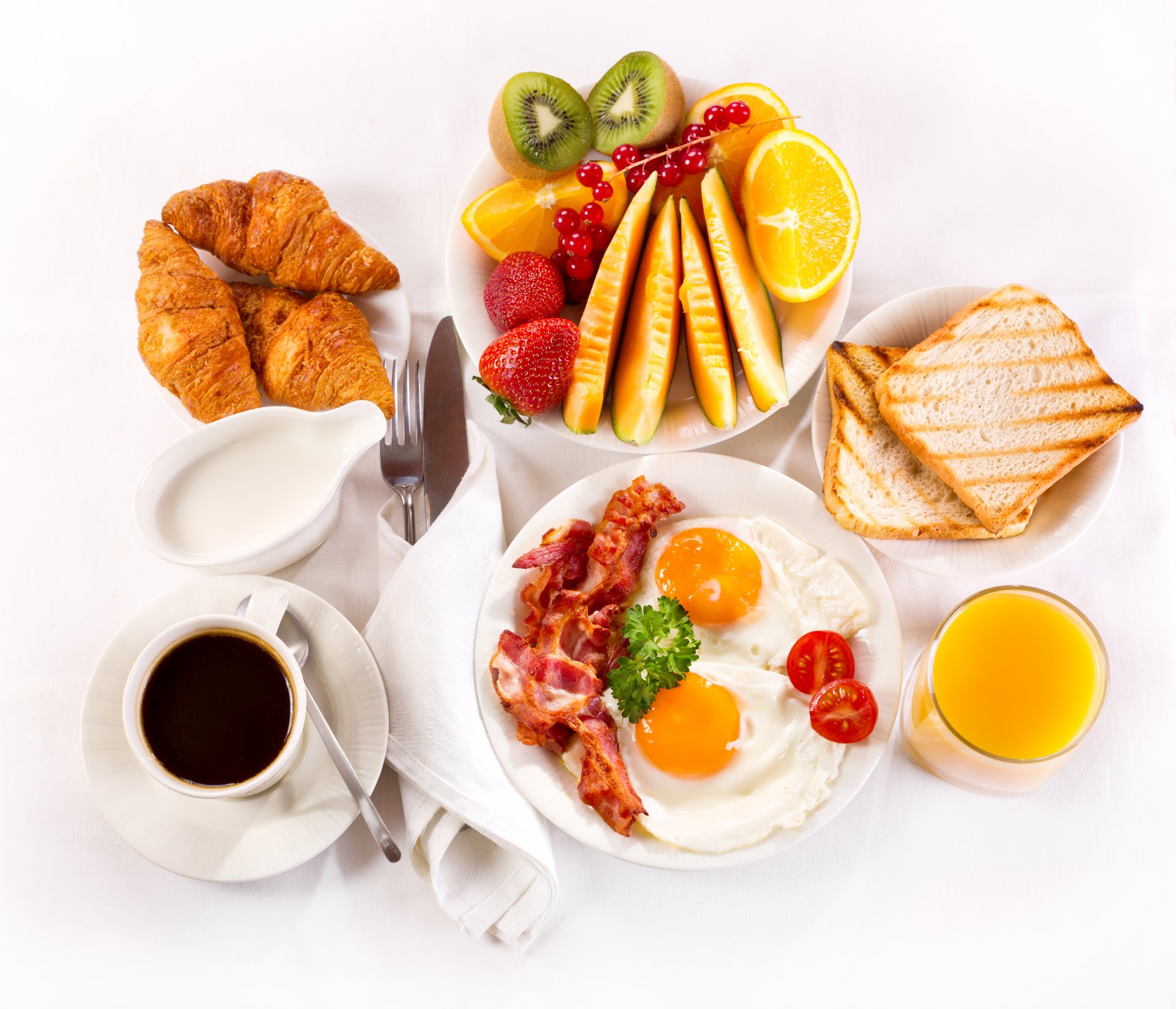 breakfast coffee fruits juice serving bacon and eggs croissant