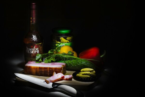 Still life of cognac, meat, herbs and vegetables