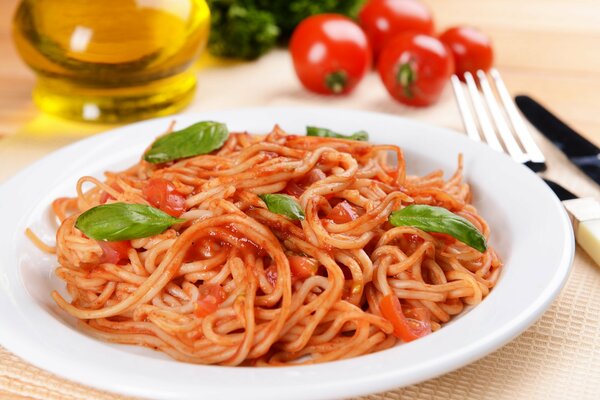 Coat in tomato sauce on a plate on the table with herbs