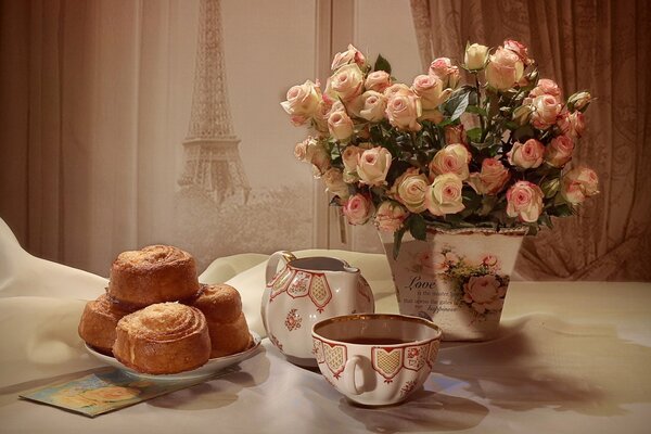 Still life with a bouquet of roses and pastries