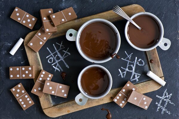 Hot chocolate and dominoes on the table