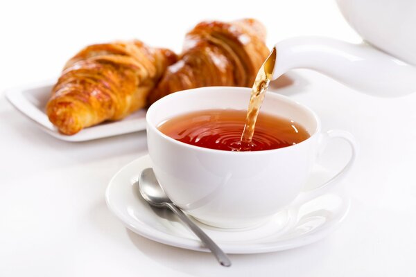 A cup of tea with a croissant for breakfast