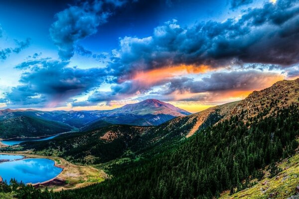 The sky in the sunset light over the lake in the mountains