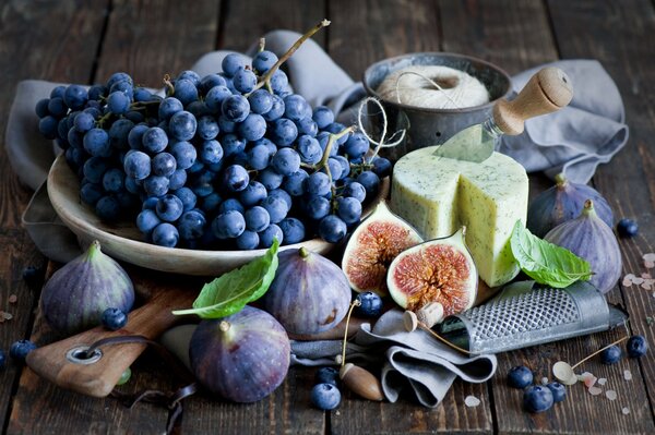 Still life cheese, figs grapes mint