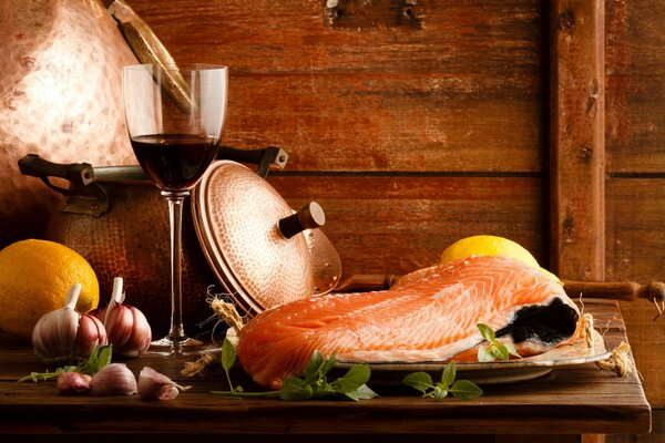 Still life of red fish with lemon and glasses